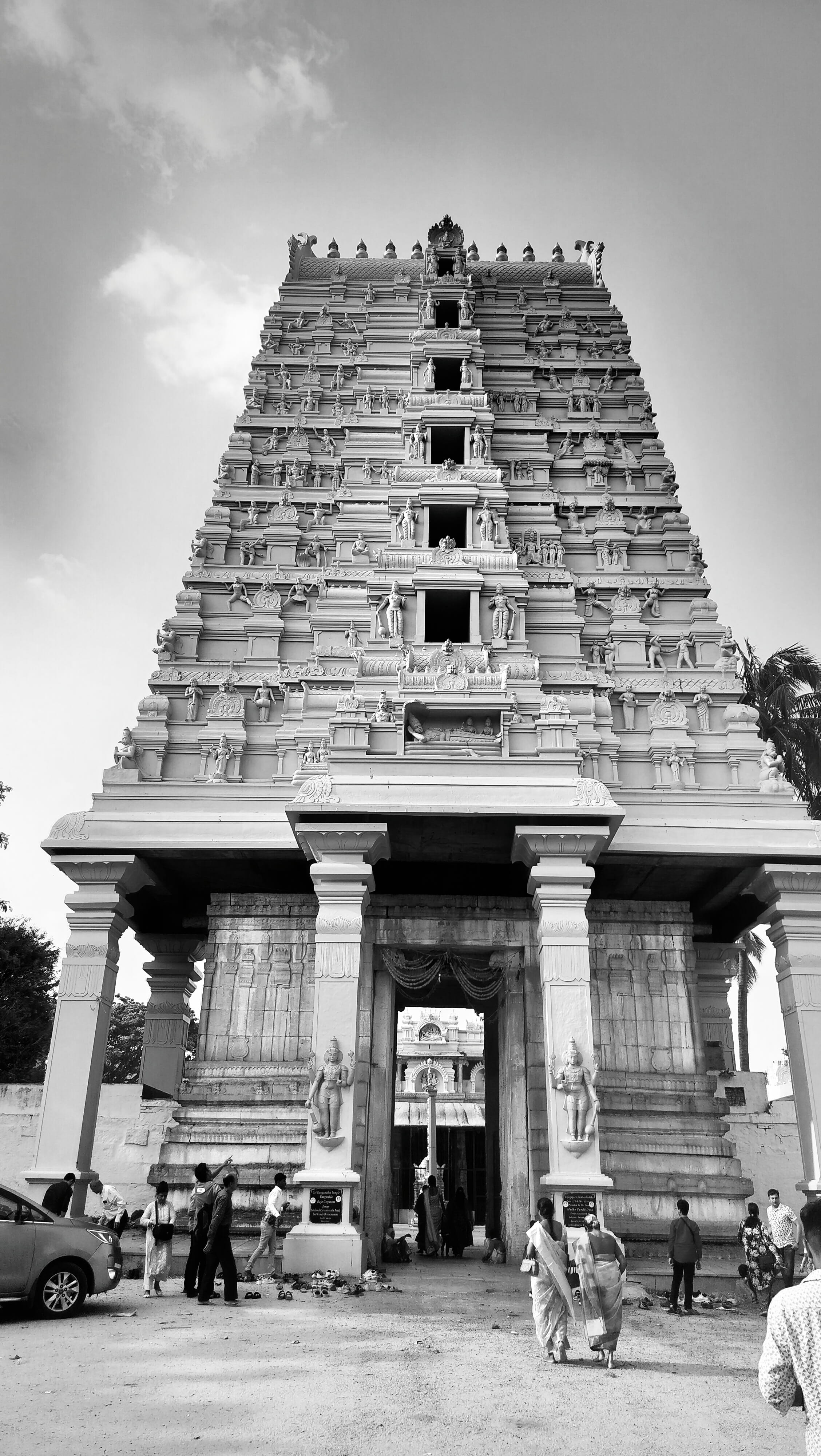 A towering Hindu temple gopuram covered in detailed stone carvings